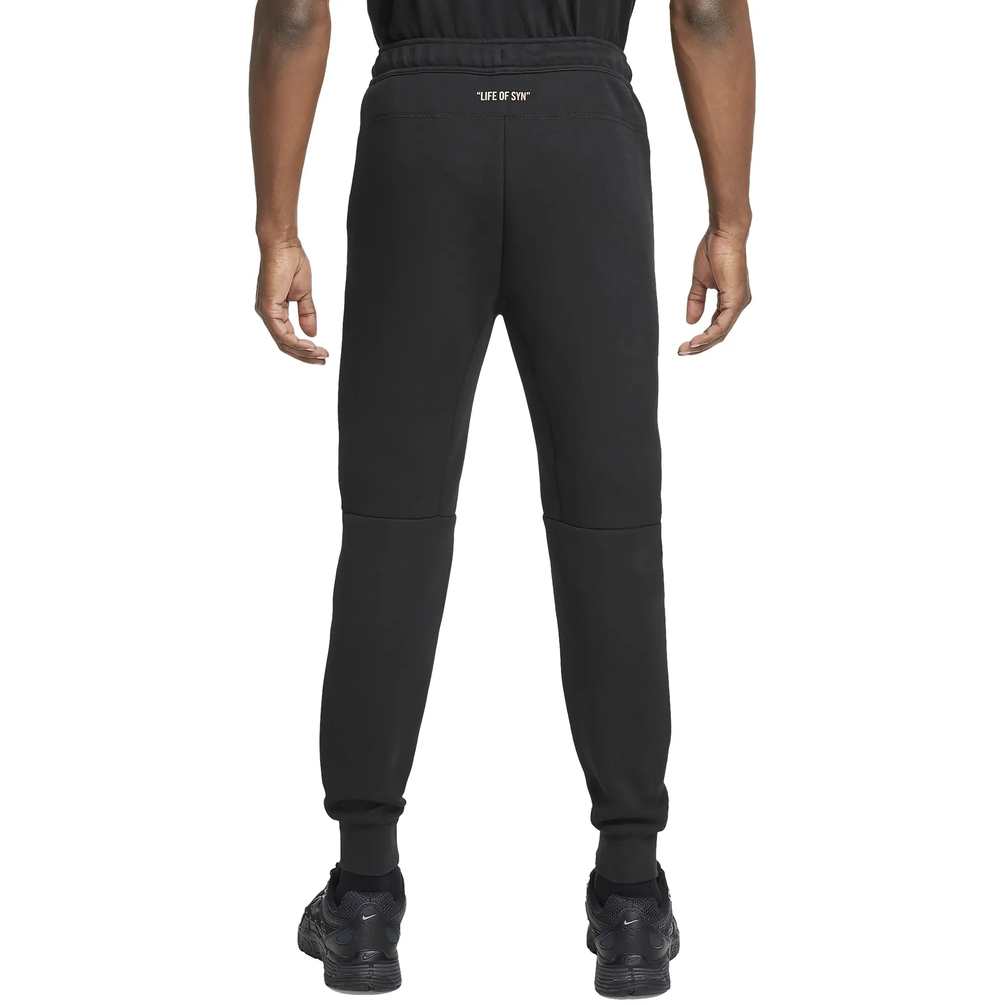 Model pants back full view of Syna World x Nike Central Cee Tech Fleece Black Tracksuit HQ3748-010 | HQ3749-010